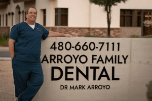 Dr. Arroyo standing next to the Arroyo Family Dental sign in Mesa, AZ